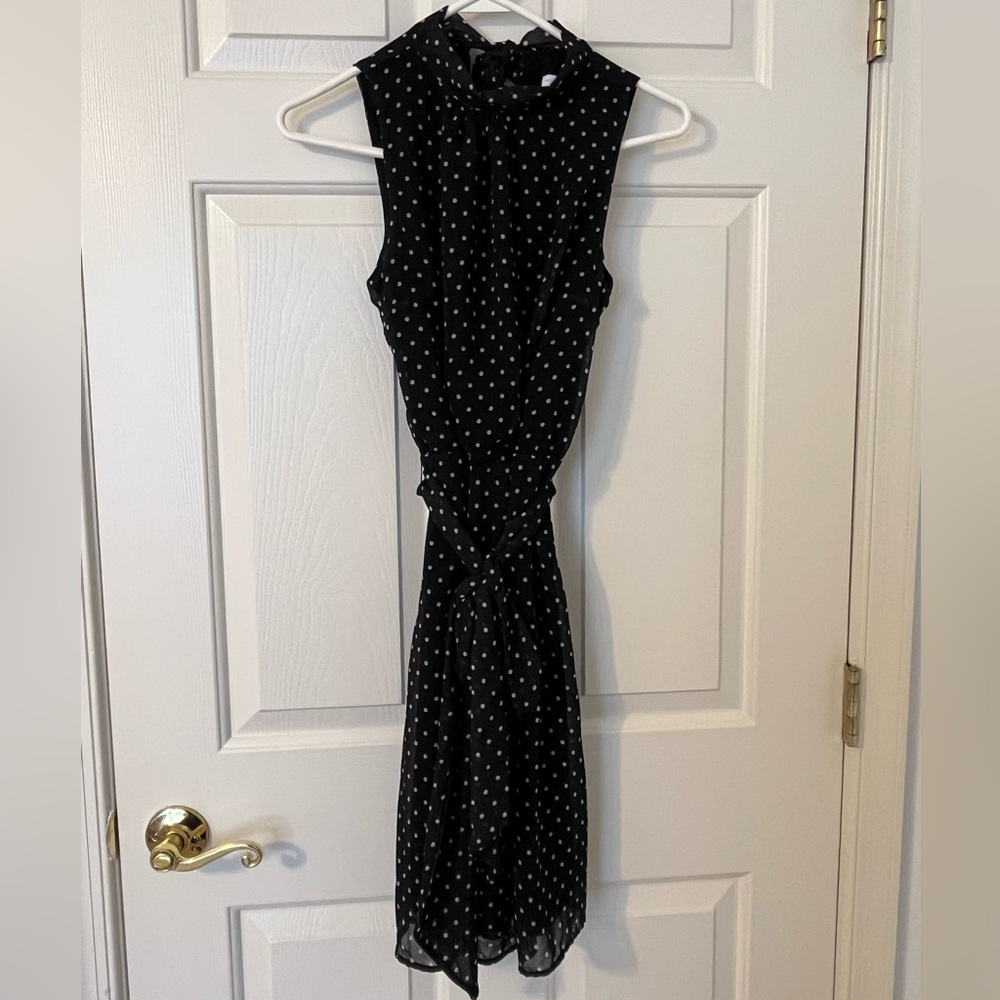 NY&Co sleeveless dress. Black with white polka dots, side zip, back neck tie.